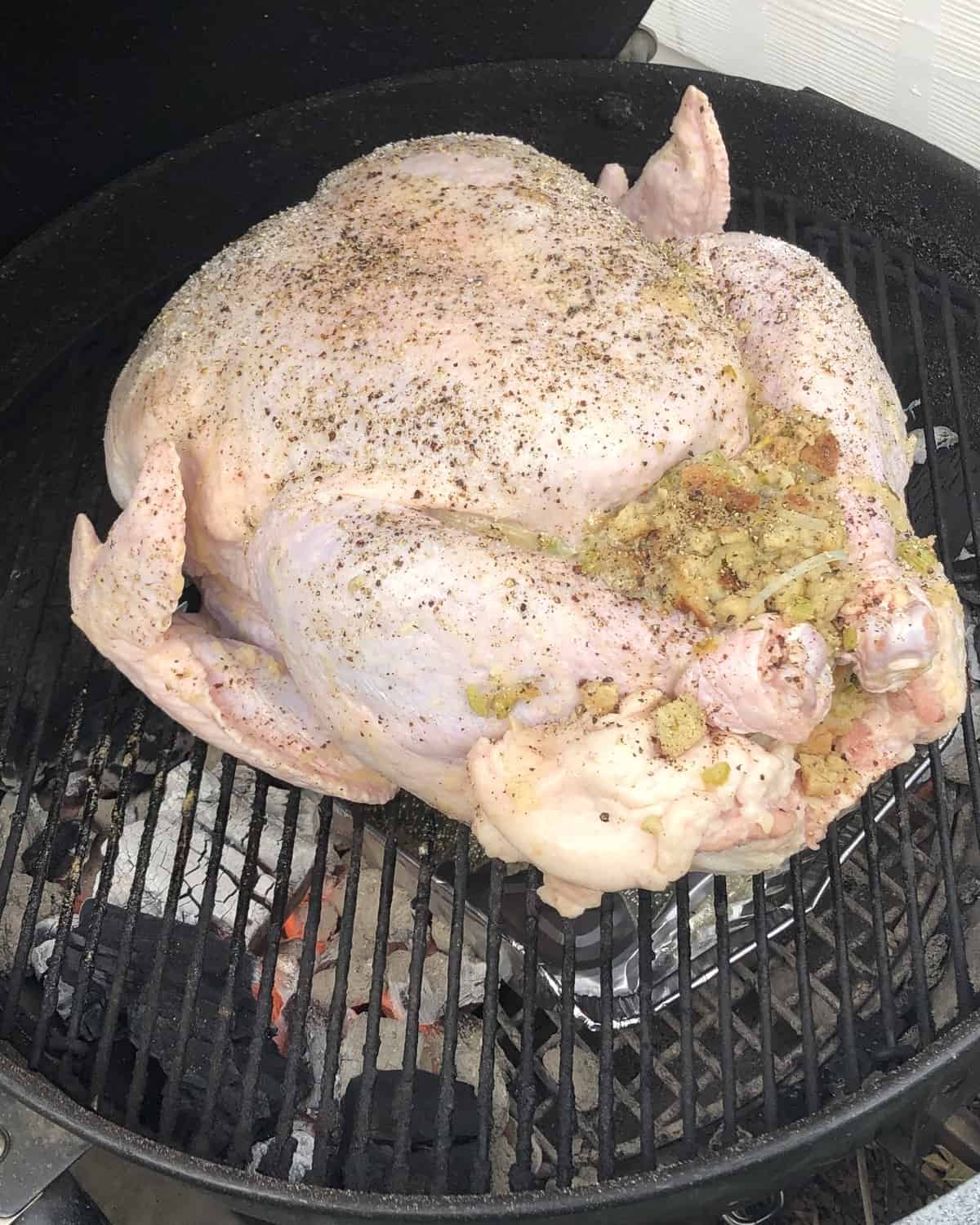 turkey with stuffing on a hot charcoal grill.