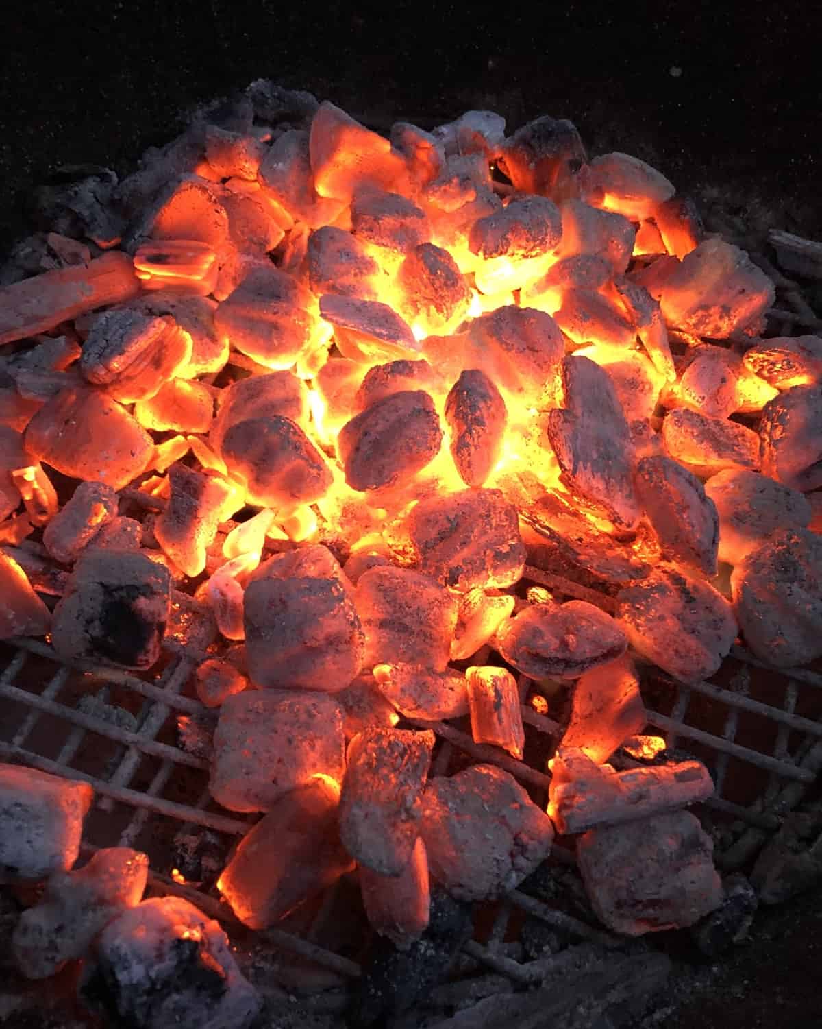 red hot charcoal in a Weber grill.