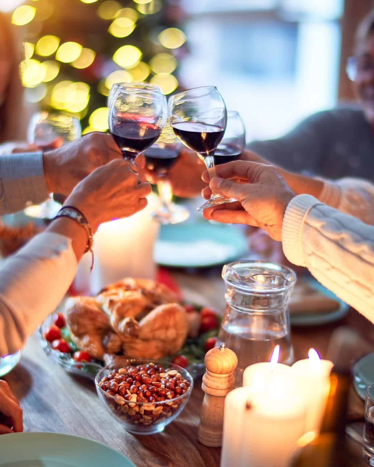 A toast with red wine at a Thanksgiving table.