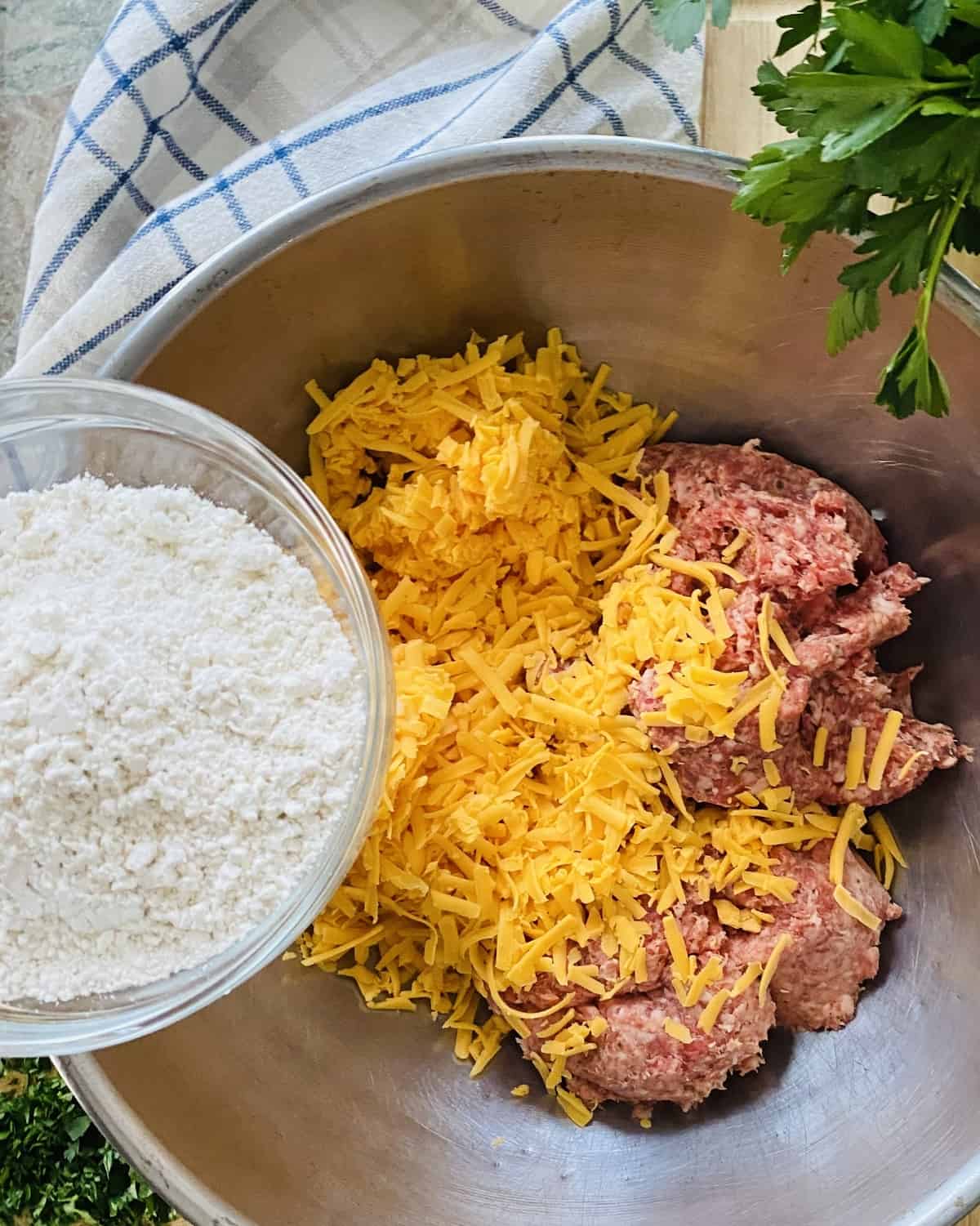 Ground pork sausage, shredded cheese in a bowl with Bisquick.