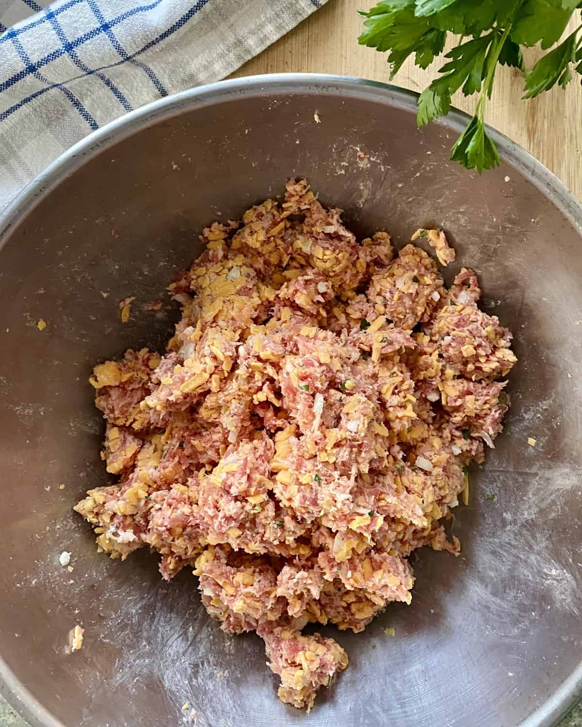 Ingredients combined for sausage meatballs.