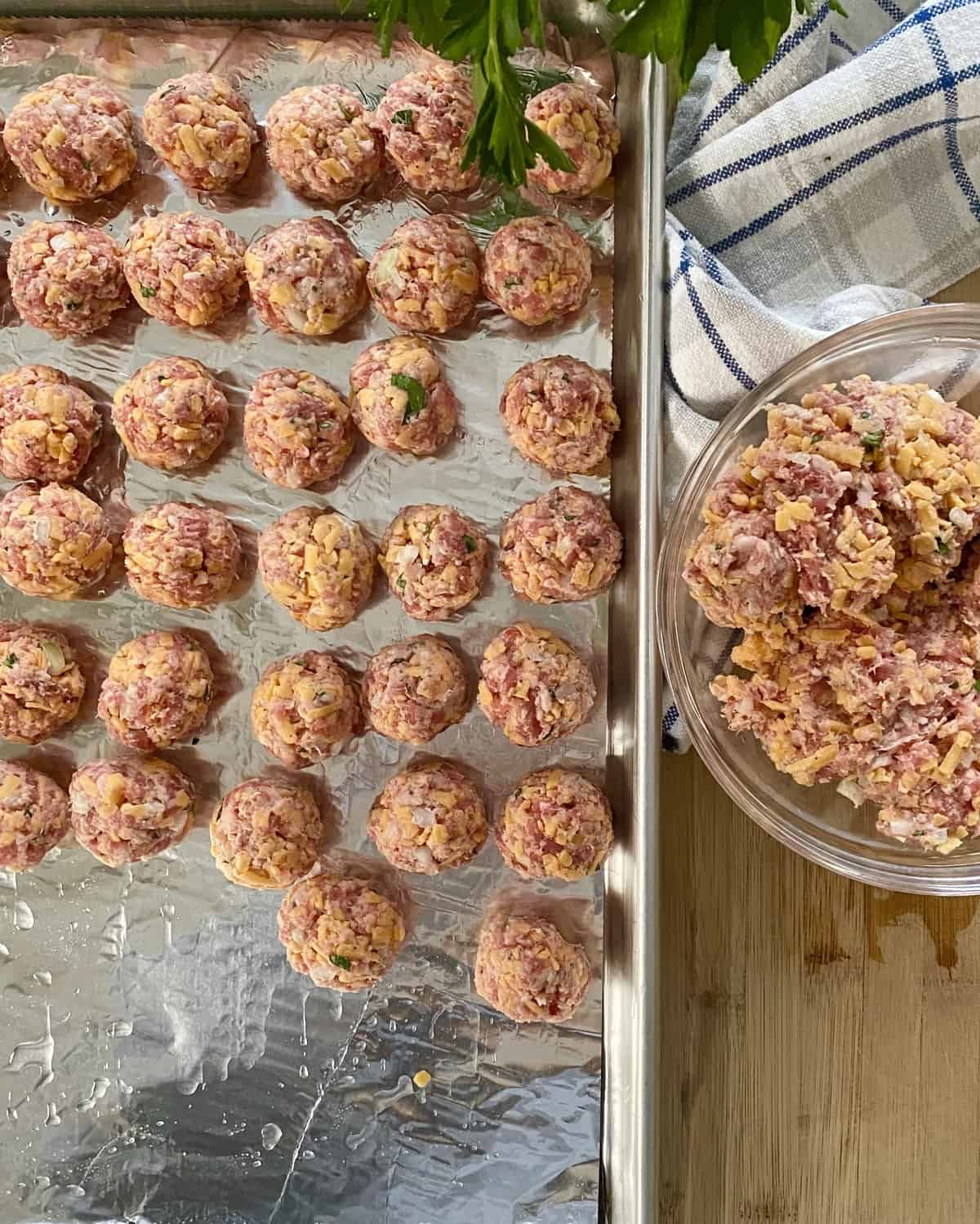 Unbaked sausage balls on a baking sheet.