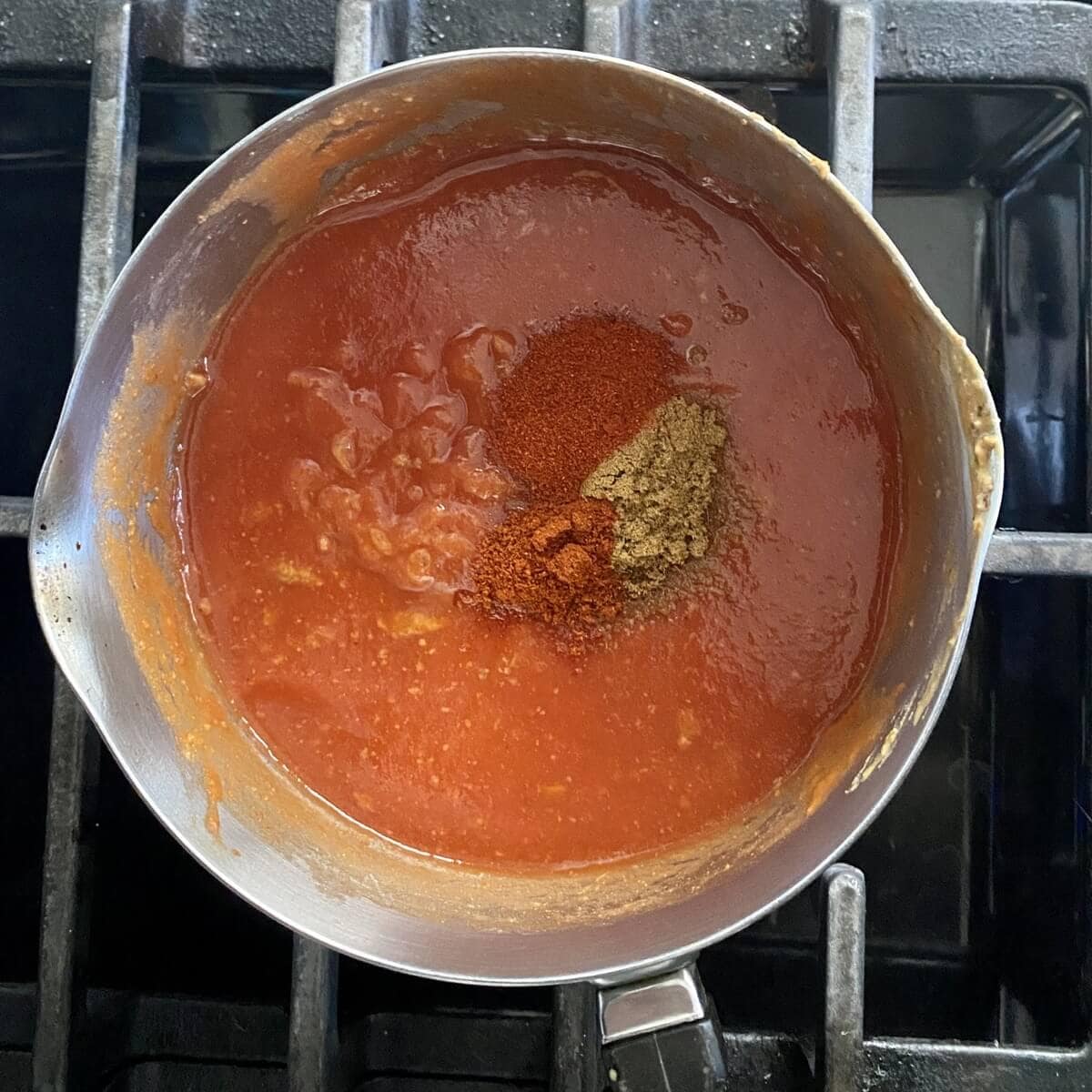 Red enchilada sauce in a pot.