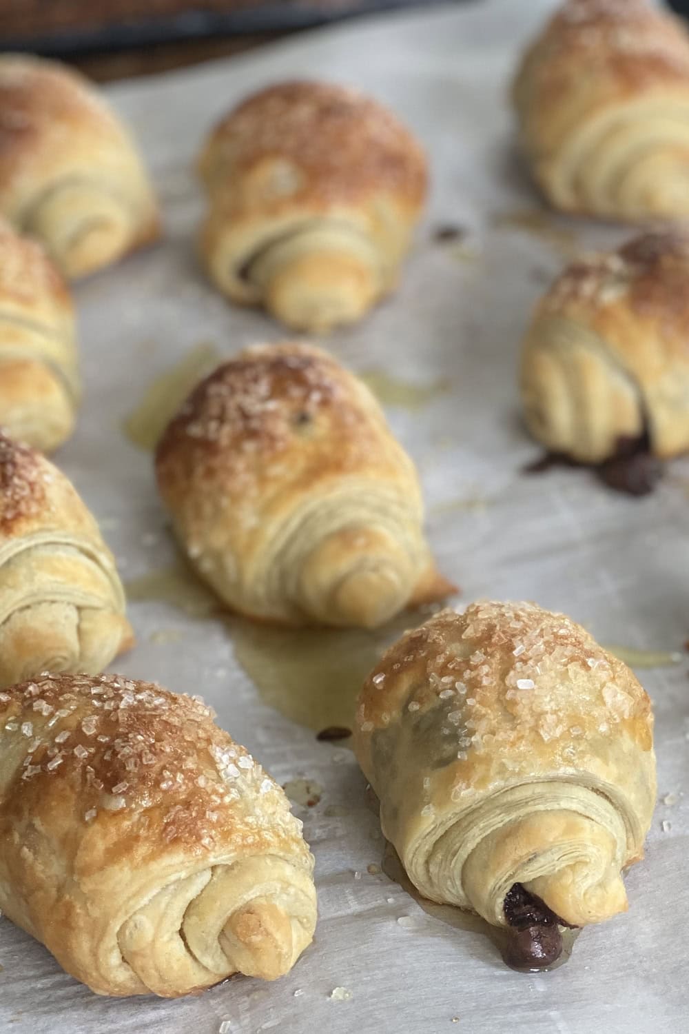 chocolate puff pastry rolls on a baking sheet