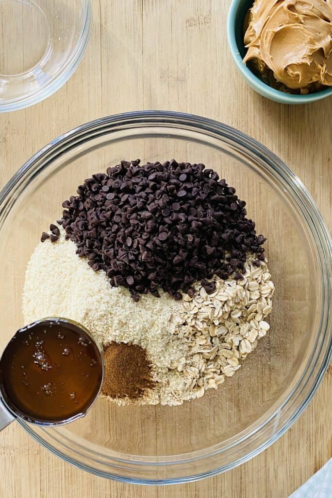 bowl with almond flour, oats, chocolate chips, honey