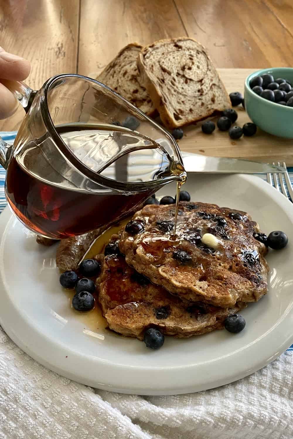 pour syrup over the the best blueberry pancake recipe