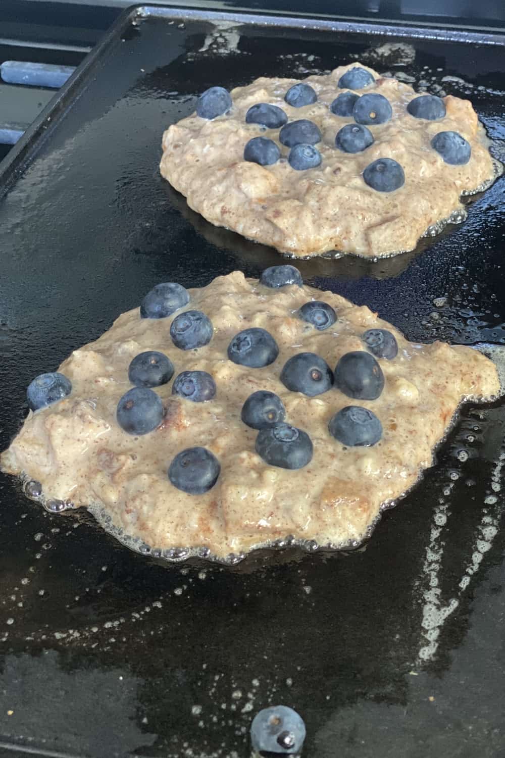cooking blueberry pancakes on a griddle