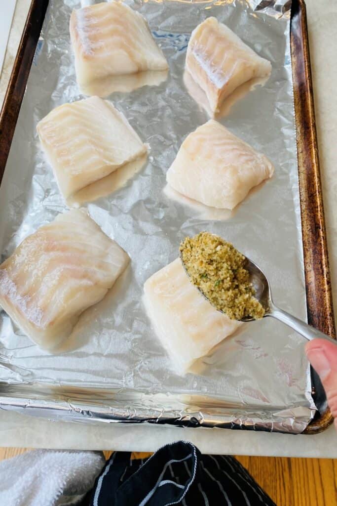 Adding a topping to cod.