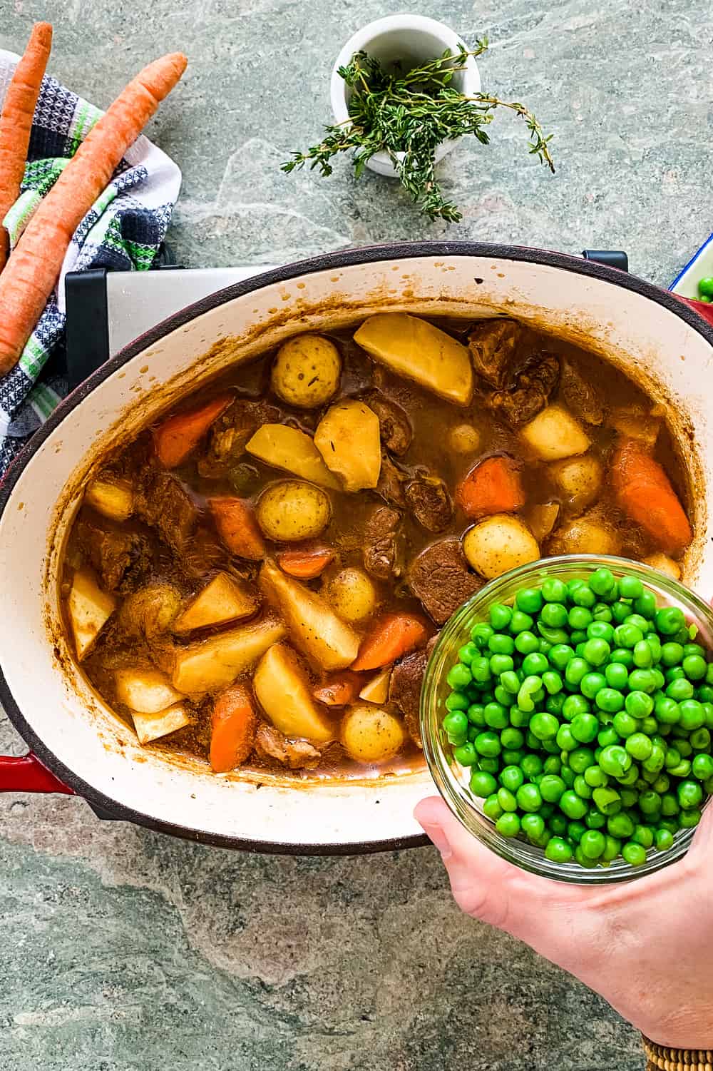 adding peas to Irish stew with lamb