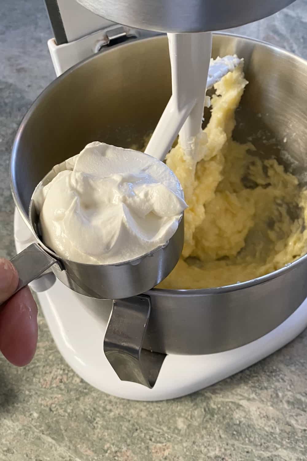 Adding sour cream to batter.