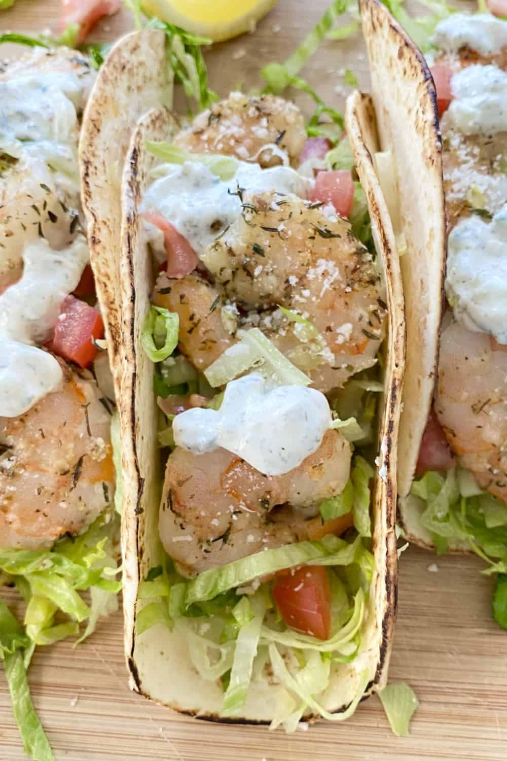 A single shrimp taco in a soft tortilla.