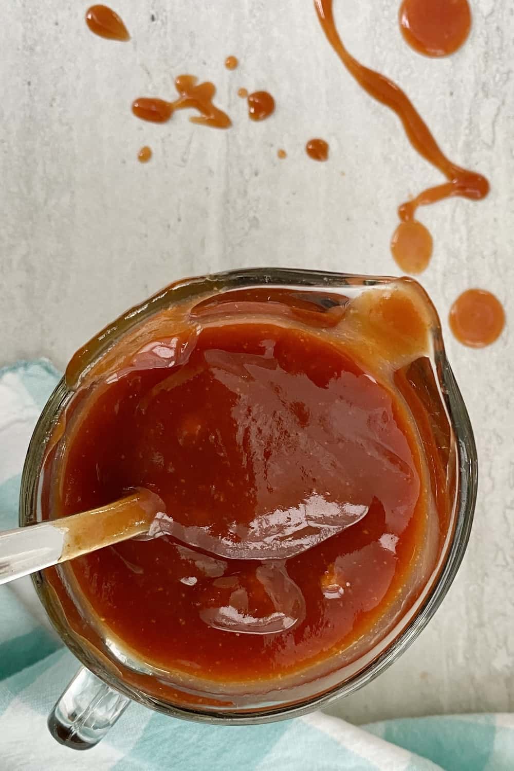 small glass pitcher filled with a a simple bbq sauce recipe