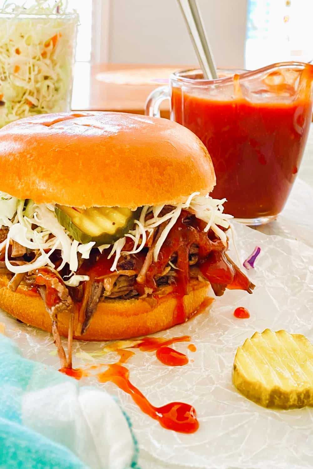 brisket sandwich with pickle and cole slaw