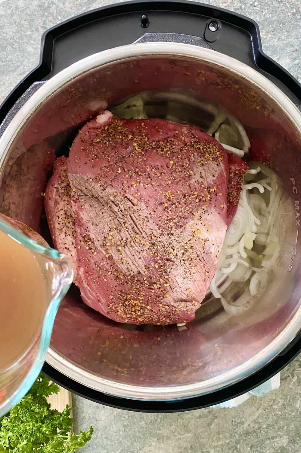 adding beef broth to Instant Pot with brisket