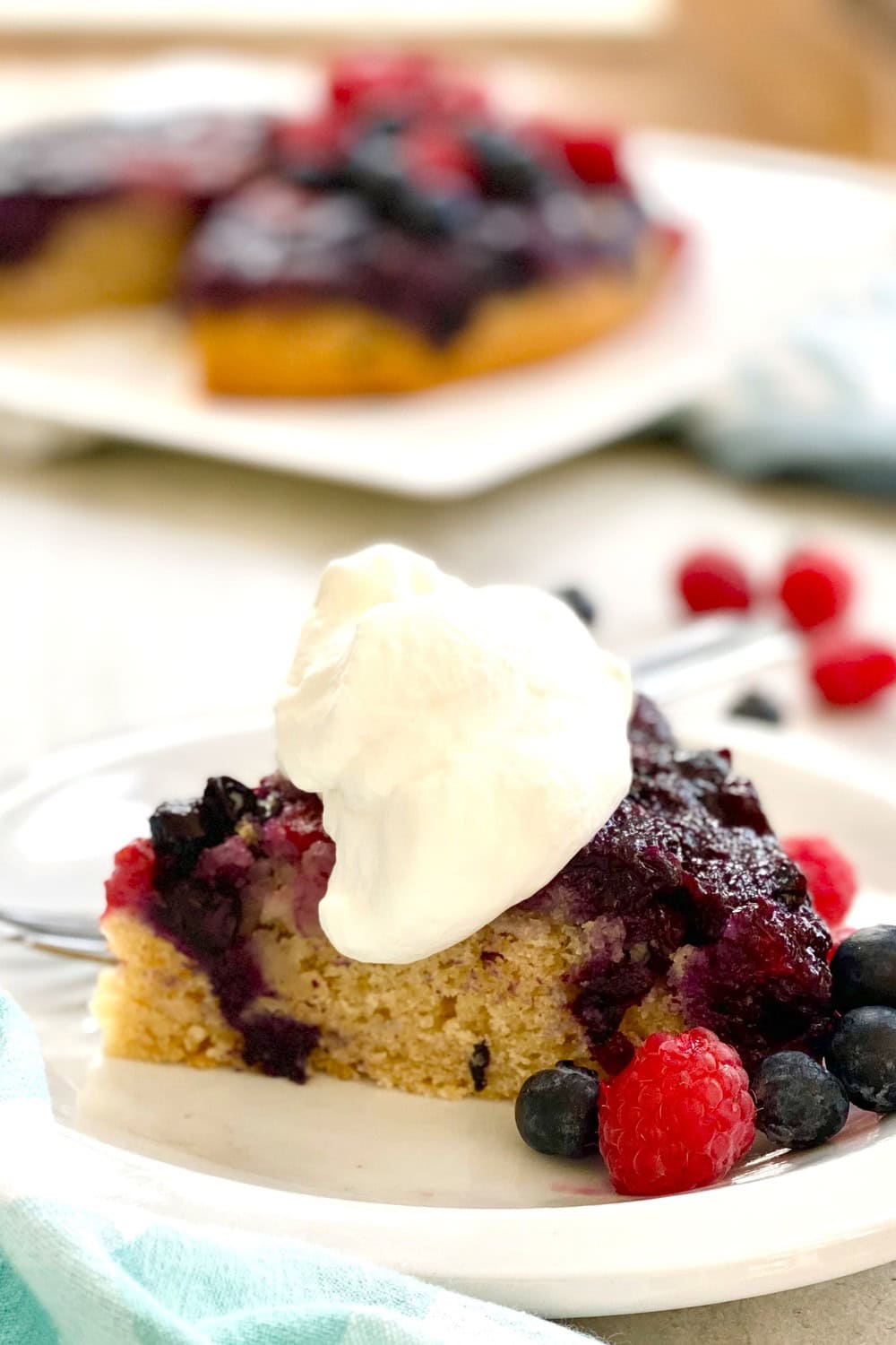 A slice of upside cake with homemade whipped cream.