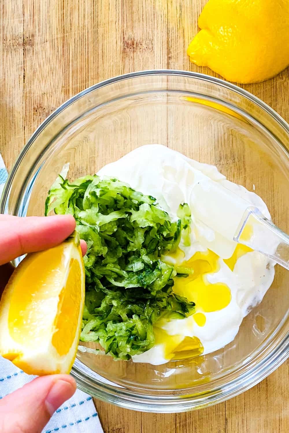 adding lemon to yogurt and cucumber dip