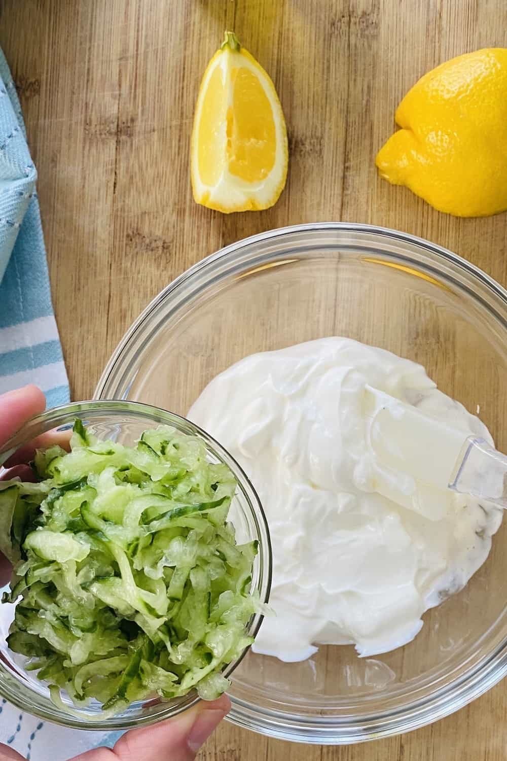 adding cucumber to yogurt