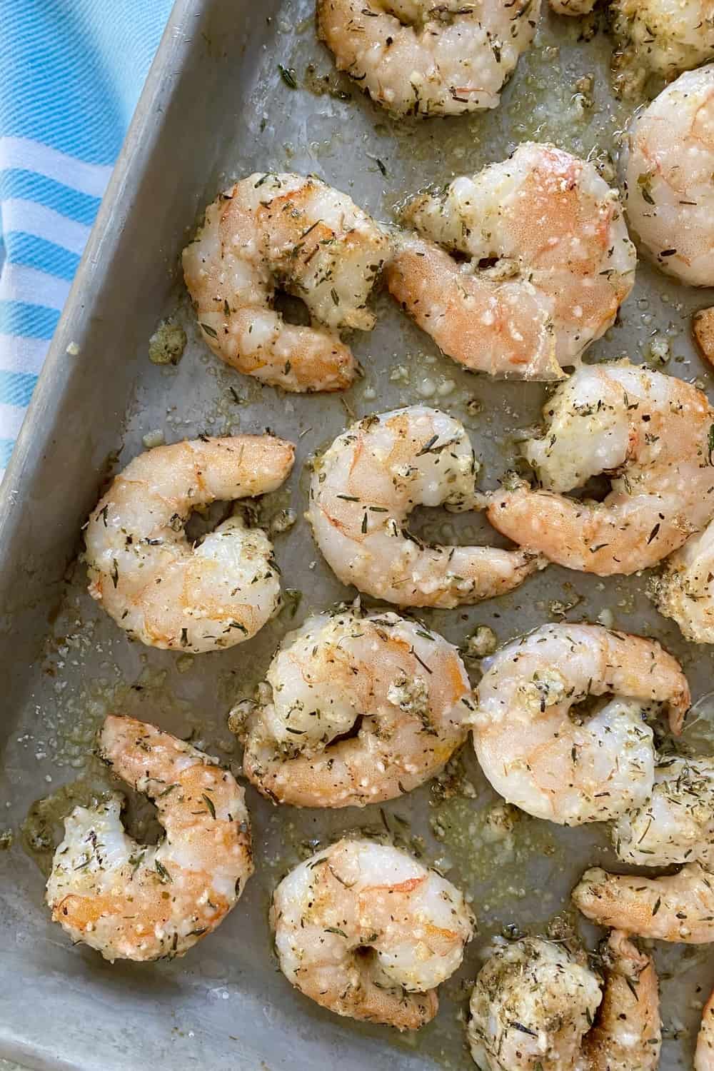 Roasted shrimp with Parmesan and garlic on a baking sheet.