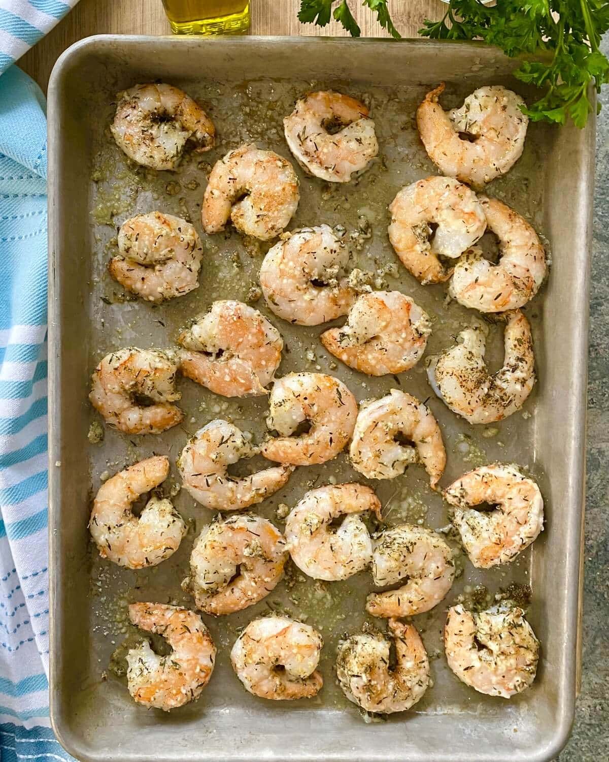 A sheet pan with cooked shrimp.