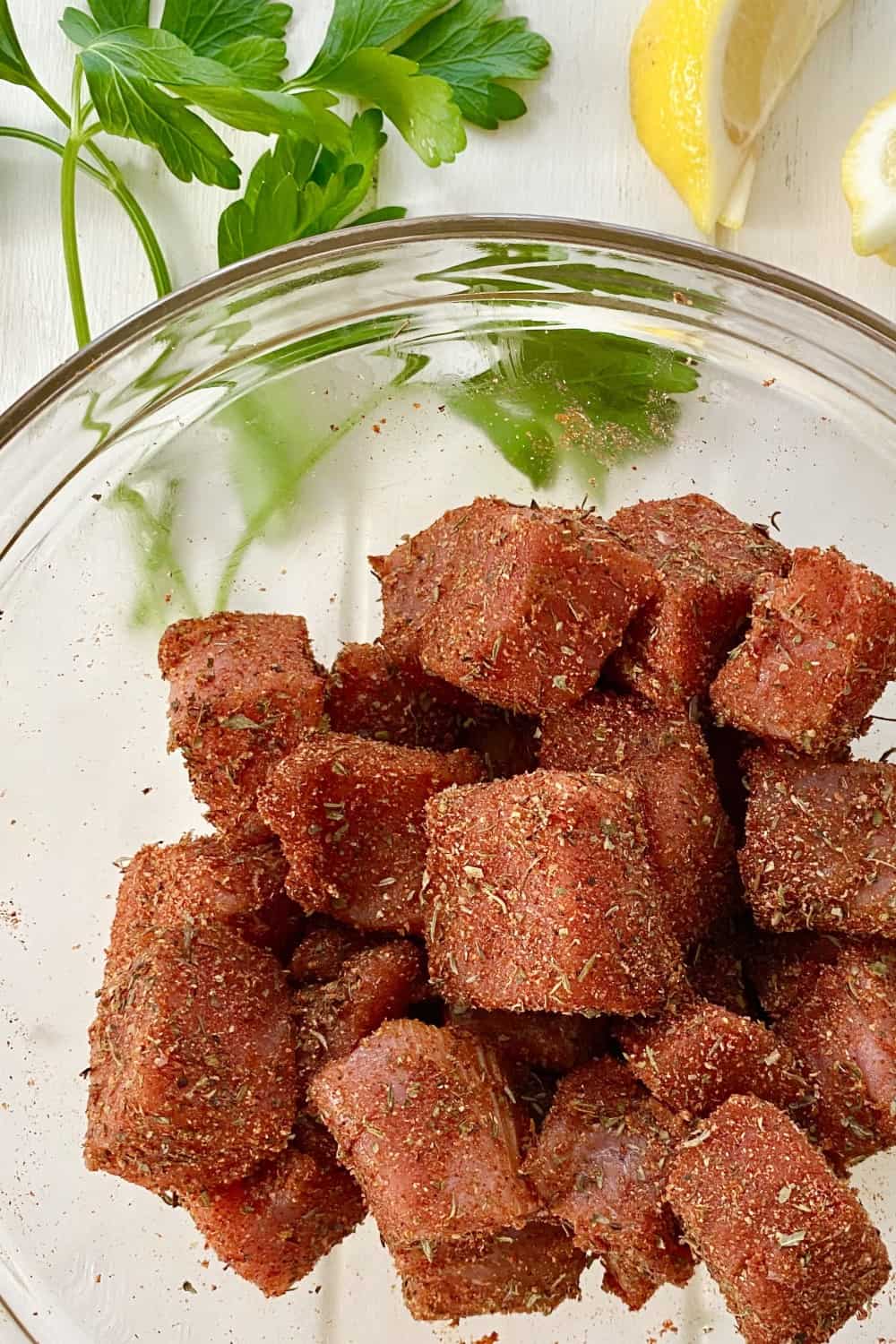 Seasoned blackened tuna bites in a bowl.