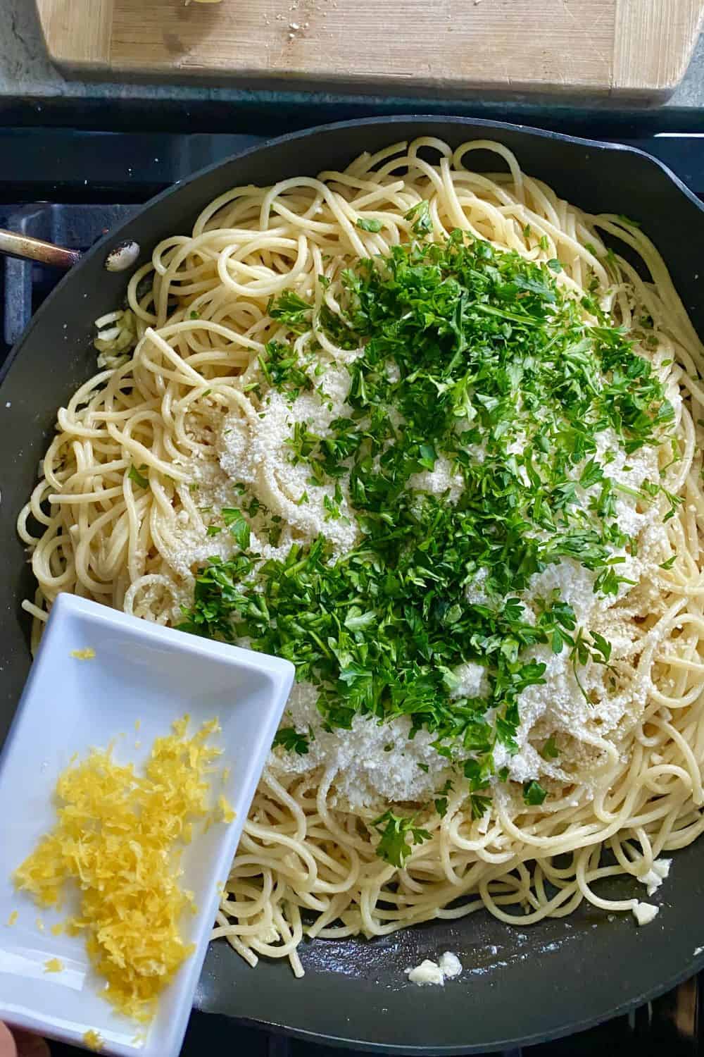 adding lemon zest to buttered noodles with Parmesan