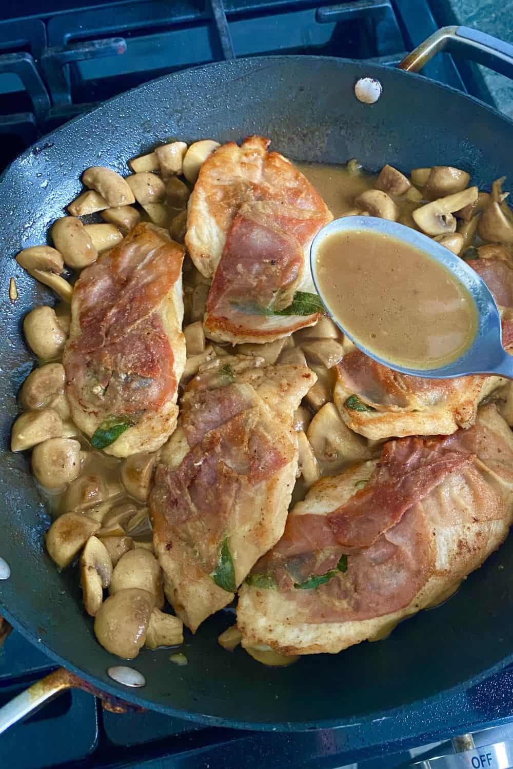 Adding sauce to a pan of cooked chicken with prosciutto.