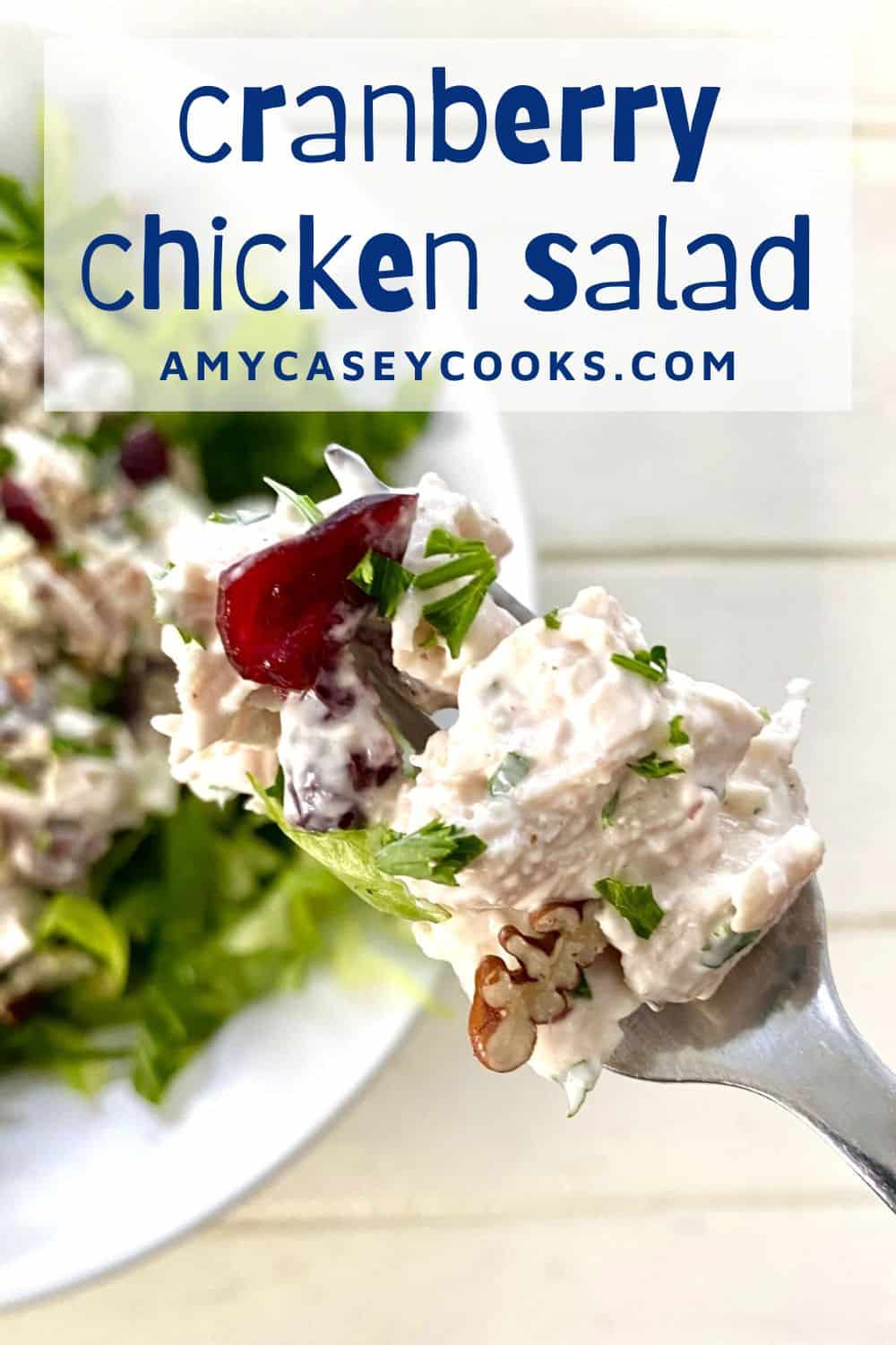 creamy cranberry chicken salad on a fork.