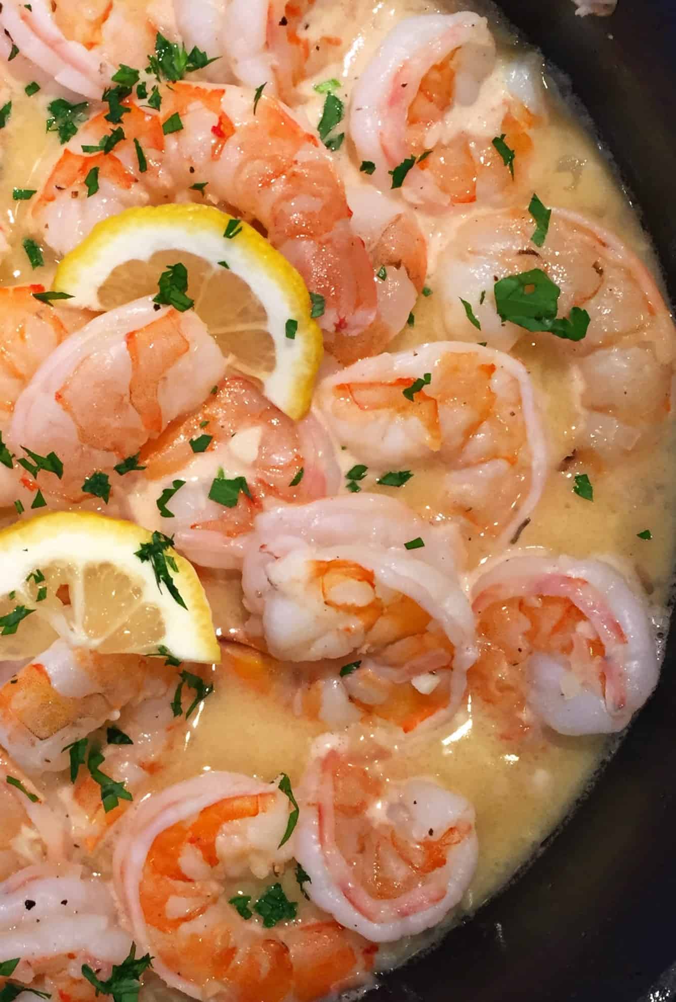 garlic butter shrimp scampi with lemons in a sauté pan.