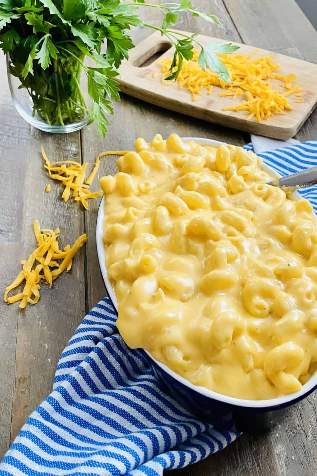 overflowing dish of super cheesy and easy mac and cheese.