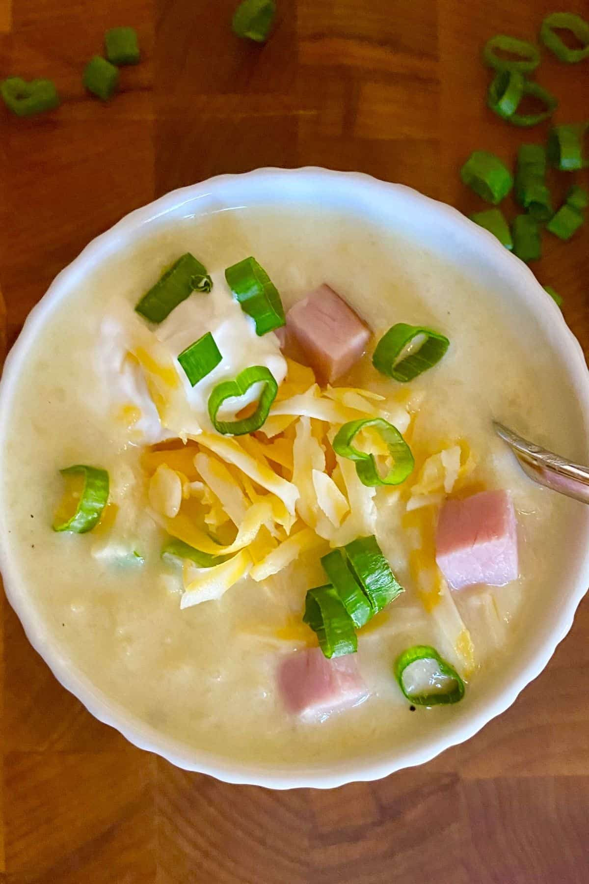 cheesy ham and potato soup topped with sour cream and scallions.