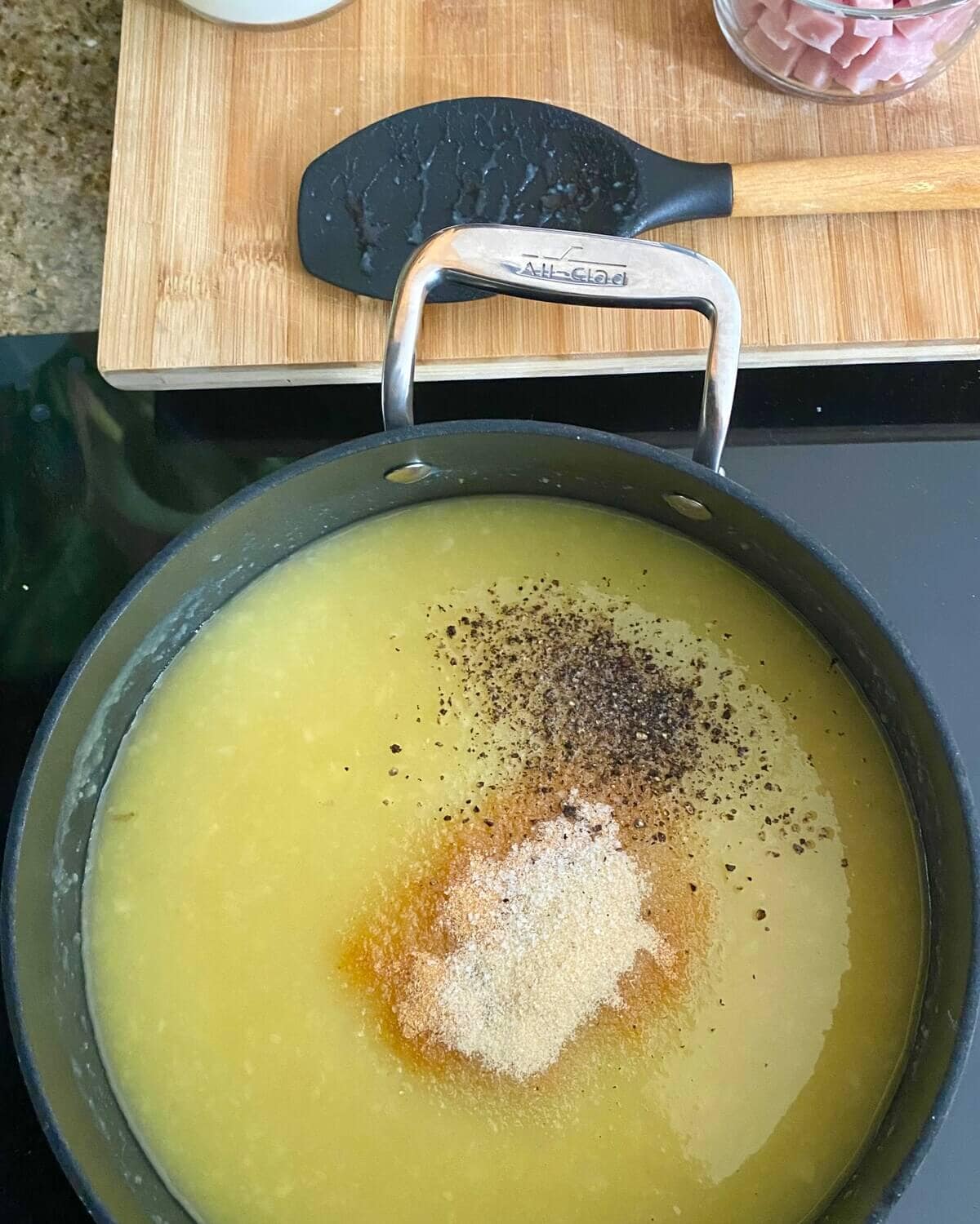 adding seasonings to soup.