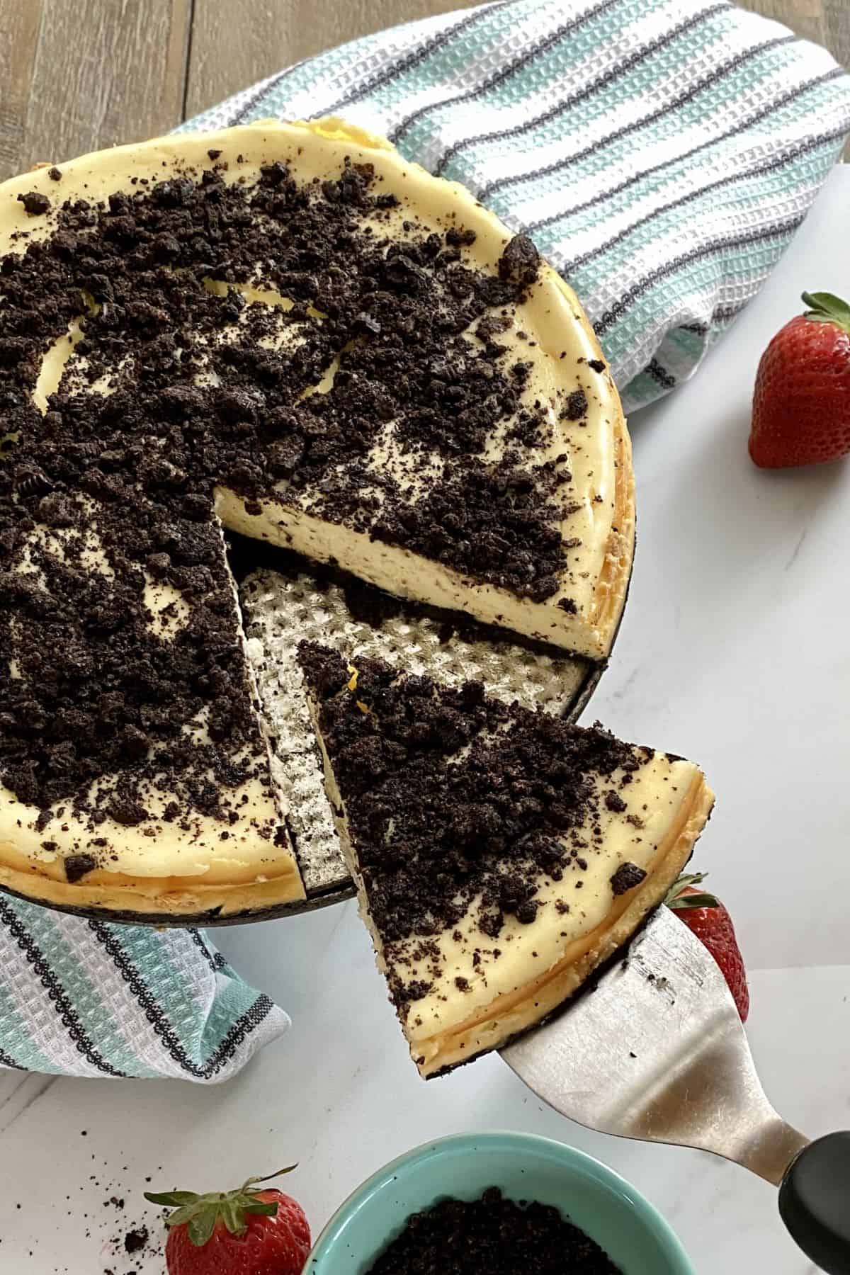 a slice cut out of an Oreo cheesecake.