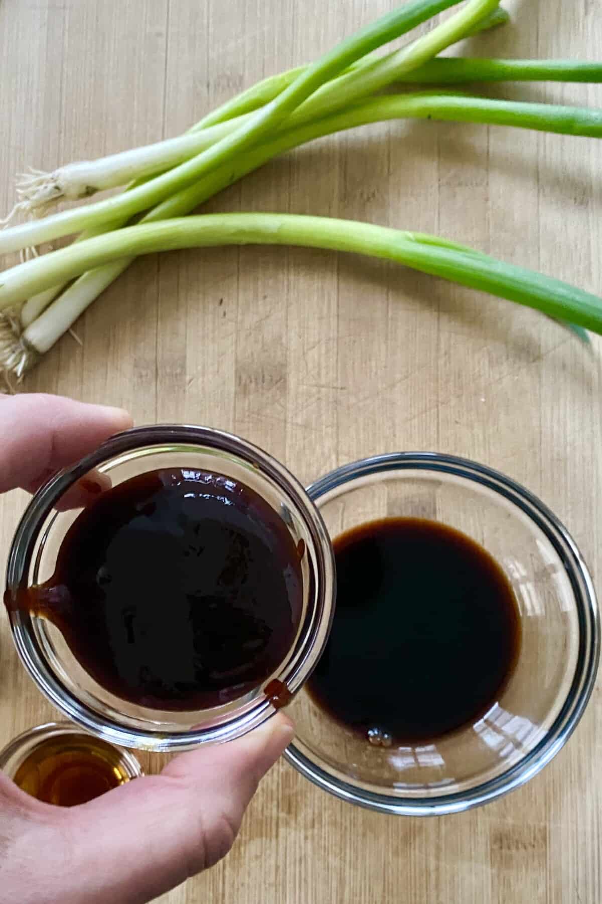 adding hoisin sauce to soy sauce.