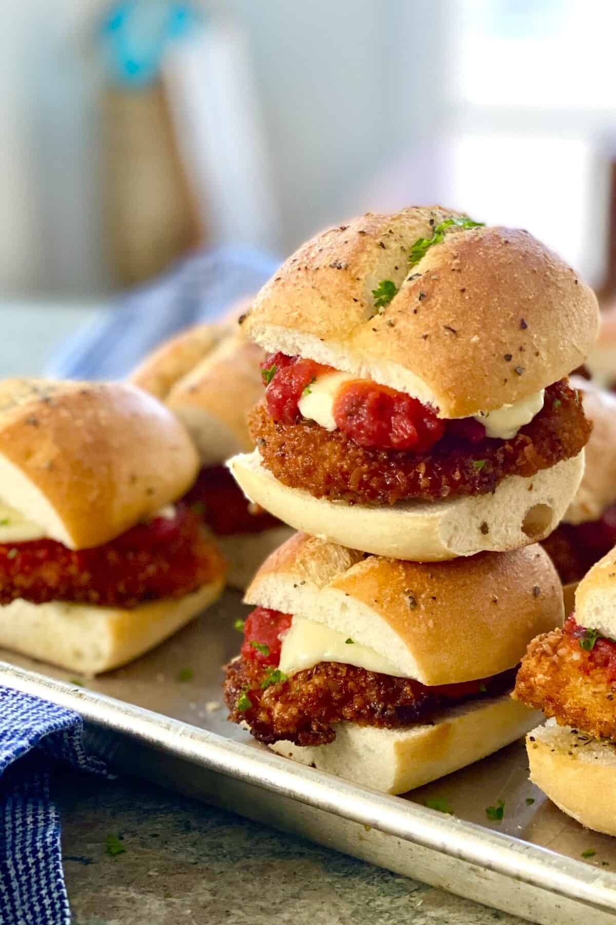 2 mini chicken parm sandwiches stack on top of each other.