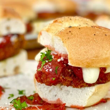 chicken parm sandwich with marinera and melted mozzarella cheese.