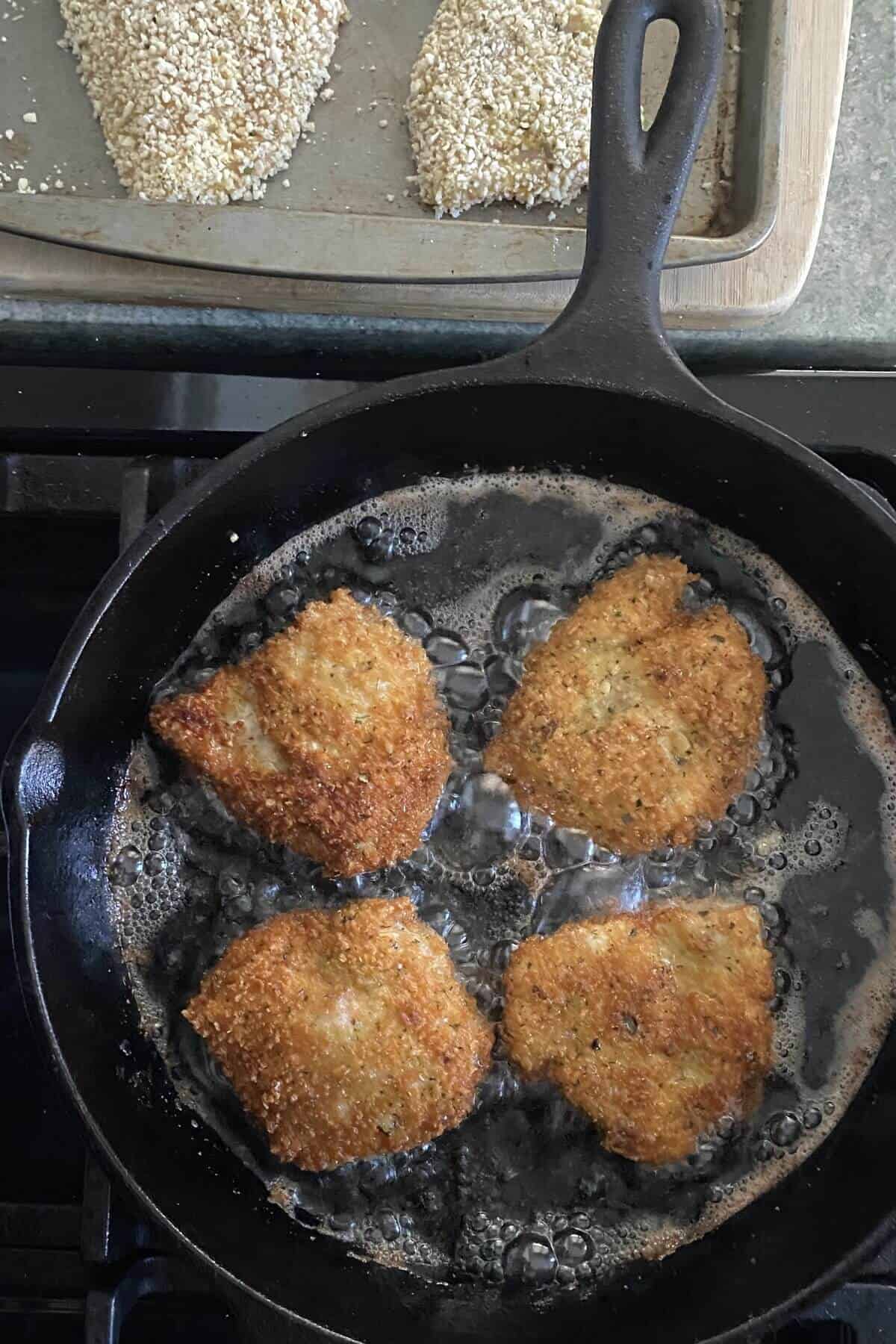 Frying chicken in a cast iron skillet.