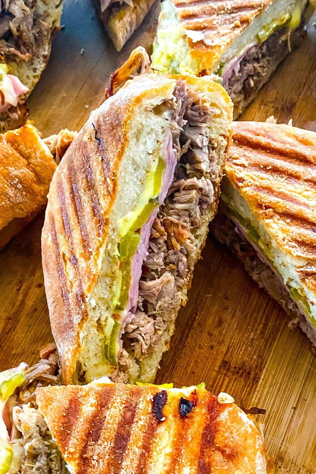 a Cuban pork sandwich cut in half.