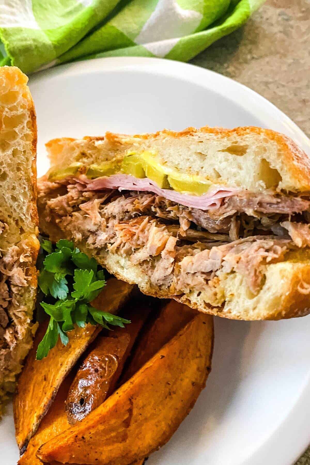 Cuban sandwich with roasted sweet potato wedges.