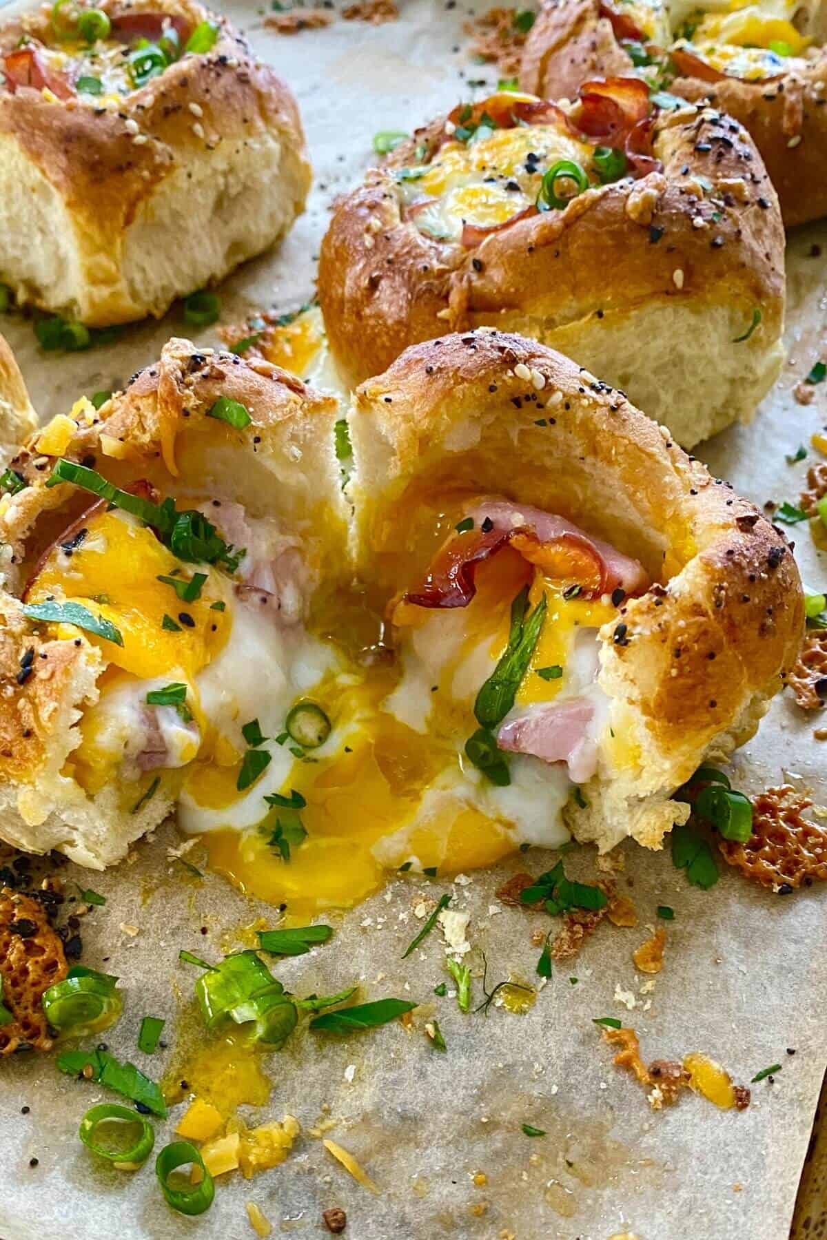 a runny egg in a ham and cheese bread bowl.