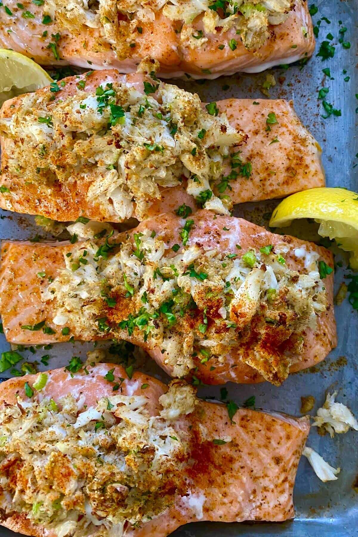 baked and stuffed salmon on a baking sheet.