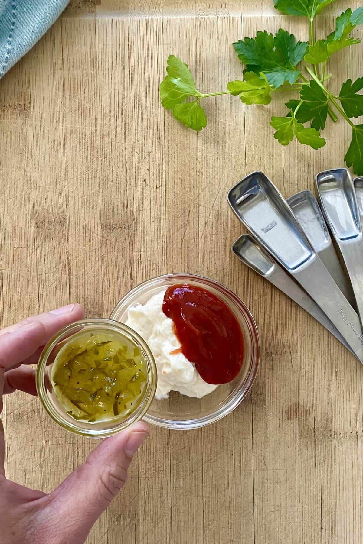 Mixing ingredients for Russian dressing in a small bowl.