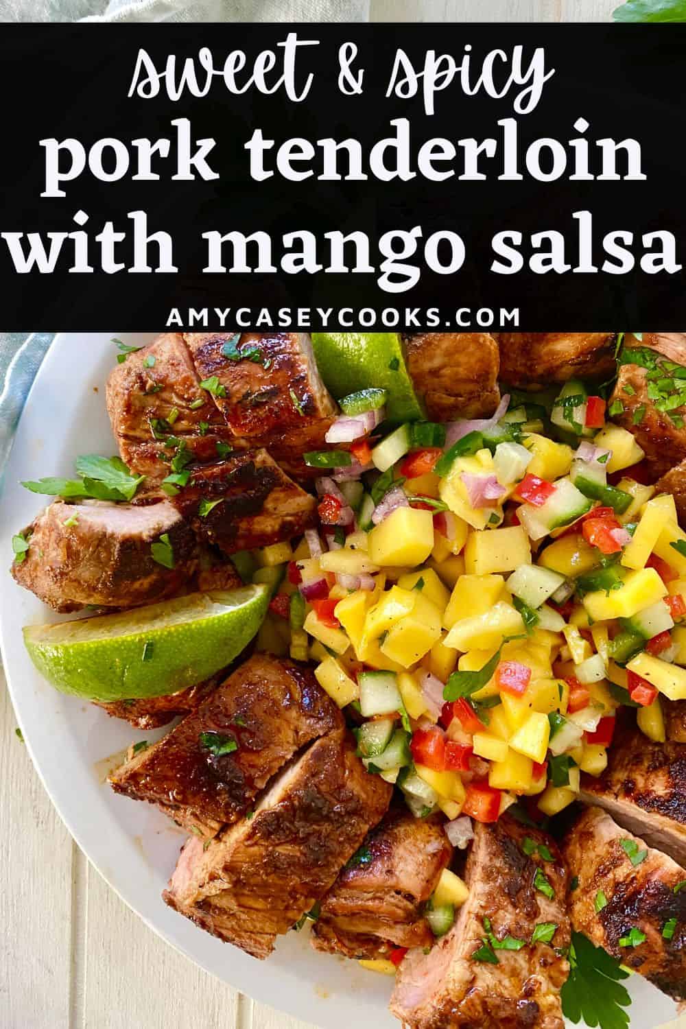A sliced pork with mango salsa and limes.