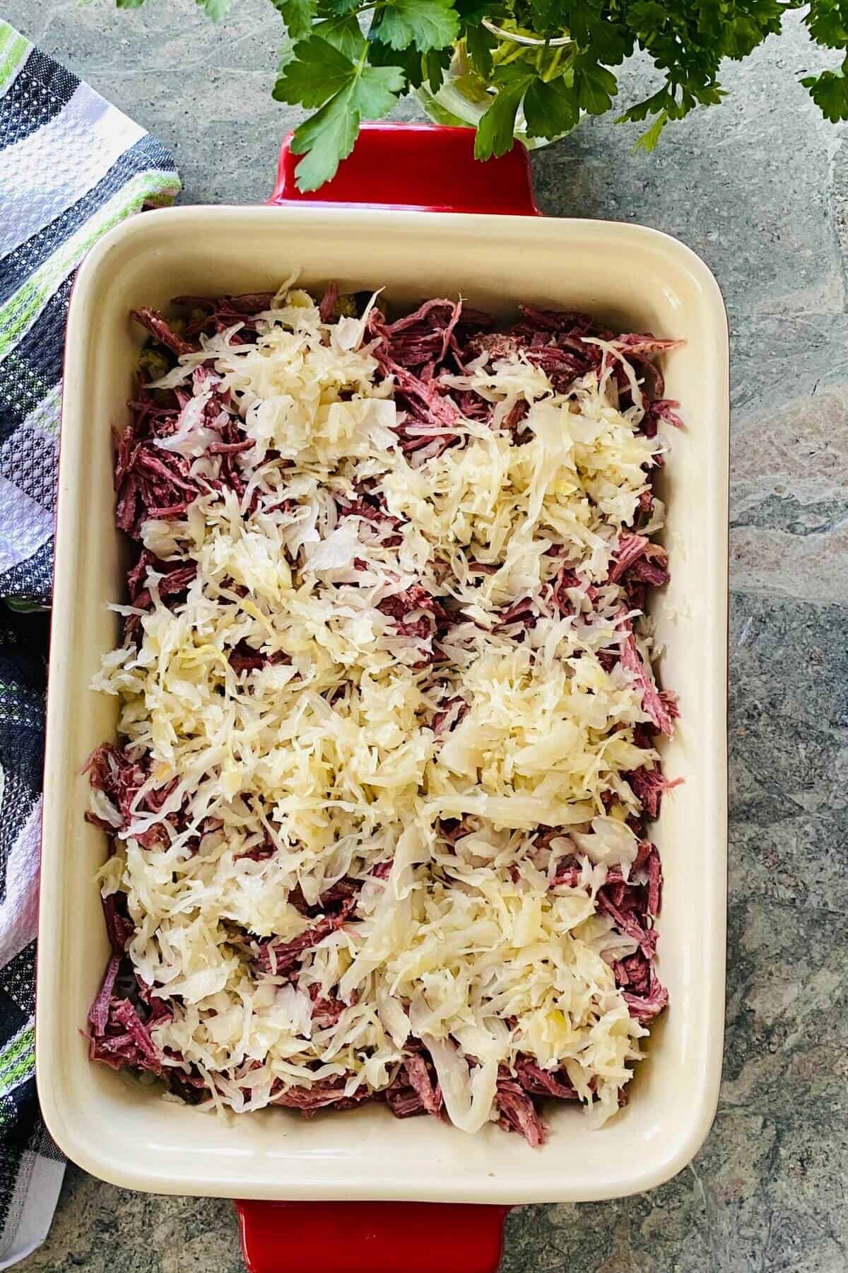 Sauerkraut on top of a reuben casserole.