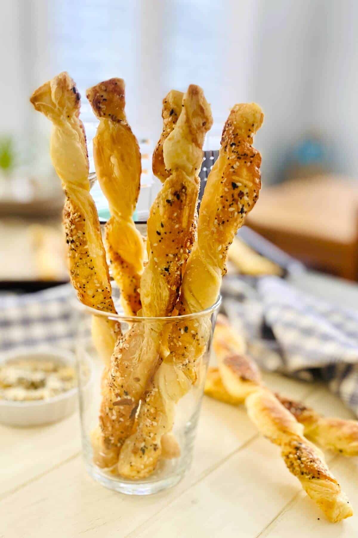 5 puff pastry cheese twists in a glass.