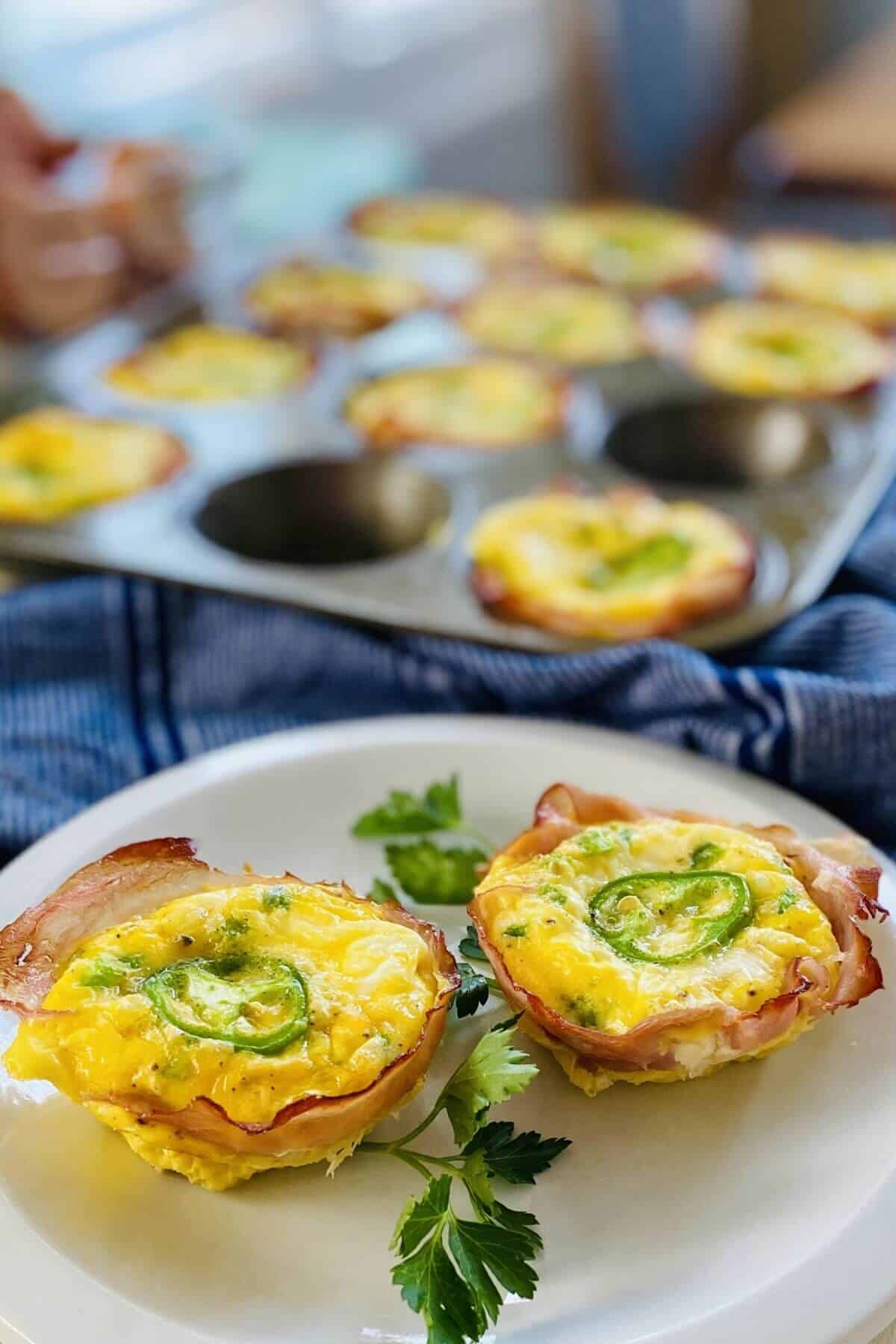2 jalapeno egg cups on a plate.
