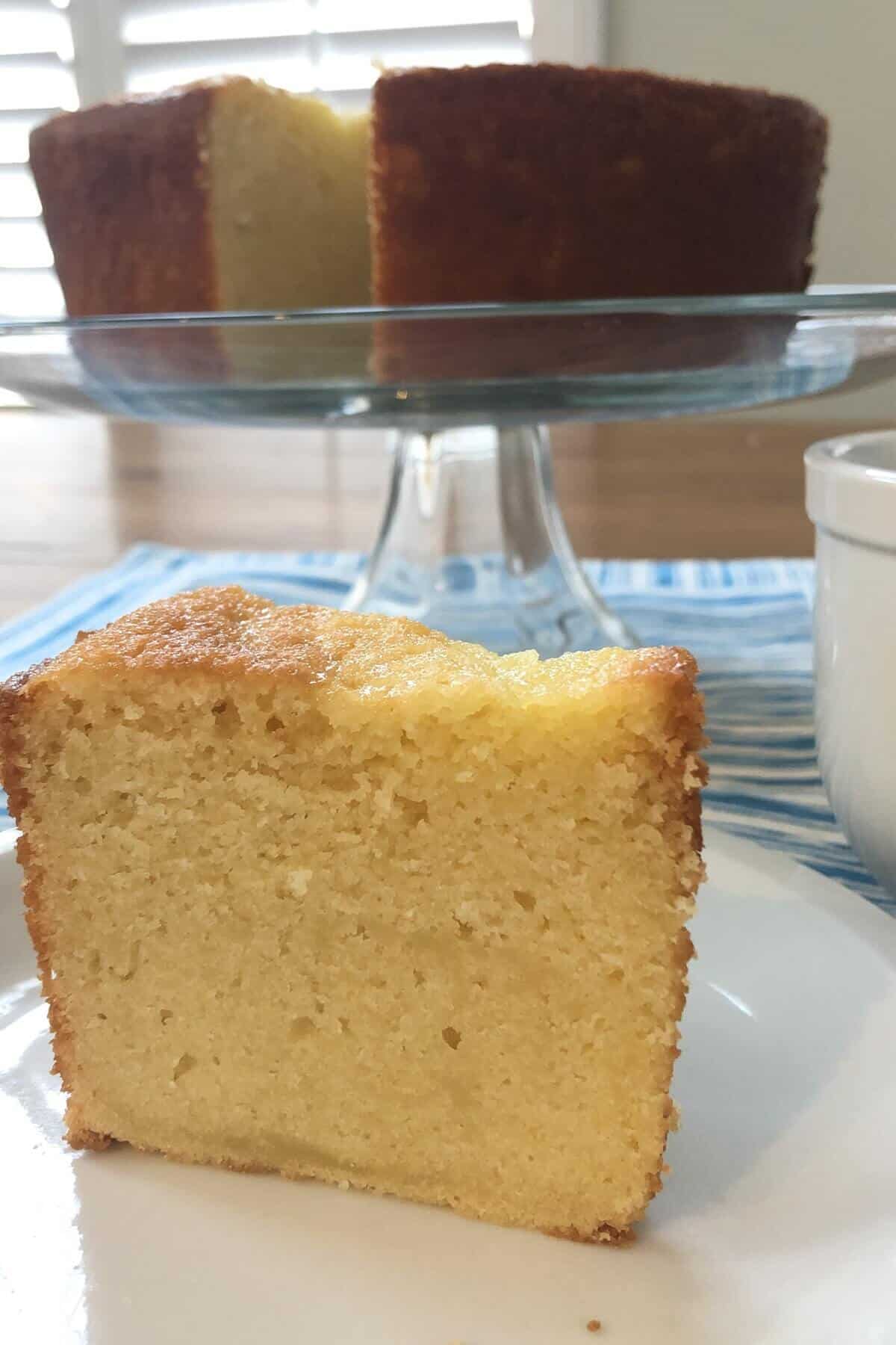 a slice of sour cream pound cake and a whole cake.
