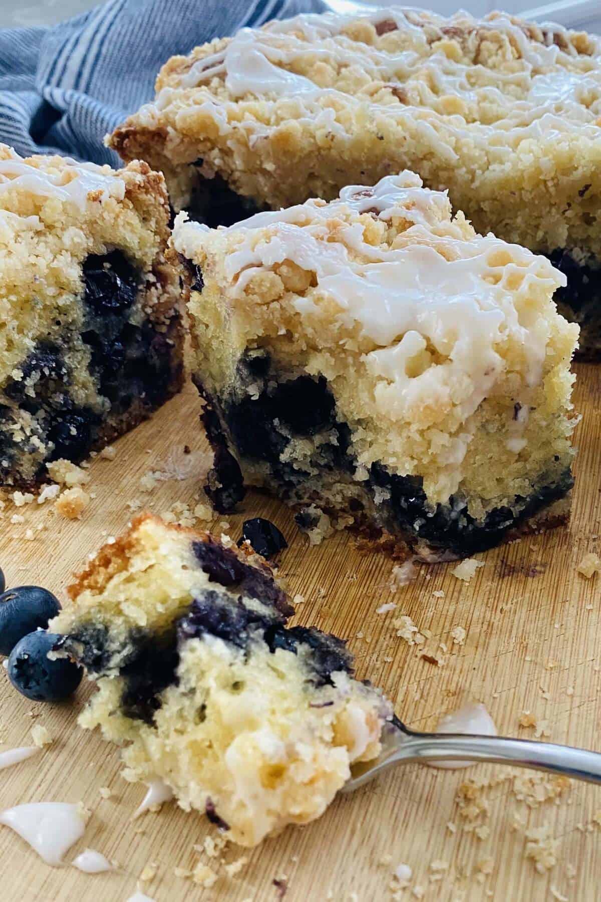 A bite of blueberry cake on a fork.