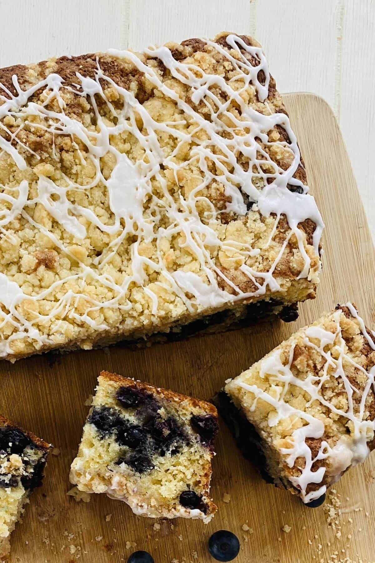 3 slices cut out of a blueberry cake.