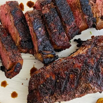sliced coffee rubbed steak and roasted potatoes.