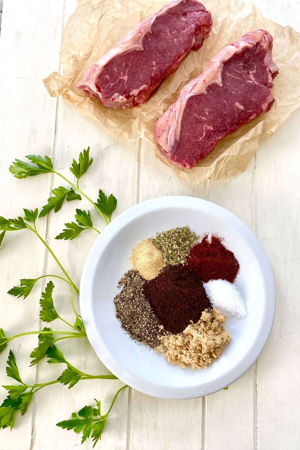New York strip steaks, kosher salt, coffee grounds, pepper, garlic powder.